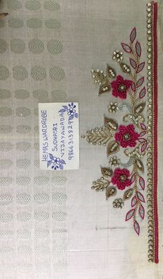 a piece of cloth with flowers on it and a tag attached to the side of it