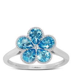 When the day calls for some color, you can’t go wrong with the strikingly vivid hue of blue topaz. Five pear cut blue topaz stones create the shape of the flower while a diamond center brings the depth of colors to life. The delicate 14k white gold beading completes the picture for a ring that’s built for your brightest days. Blue Flower-shaped Diamond Jewelry, Blue Topaz Jewelry, Flower Band, Topaz Jewelry, Blue Topaz Stone, Topaz Stone, Diamond Flower, Ring Size Guide, Pear Cut