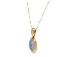 With its earthy, modern design and shimmering luminescence, this Ten Thousand Things necklace has a perfectly weighty feel. The smooth rainbow moonstone oval is encased in a molten, weighty 14K yellow gold pendant. It connects to a wide 14K yellow gold bale along the 14K yellow gold chain. total length : 16" : 14K yellow gold14K yellow gold and moonstone pendant : 1 3/8" x just over 1/2"moonstone : 15mm x 11mm14K yellow gold hook and eye clasp closure Modern Yellow Gold Jewelry With Oval Cabochon, Modern Yellow Gold Oval Cabochon Jewelry, Modern Gold Jewelry With Oval Cabochon, Yellow Gold Moonstone Pendant Necklace, Yellow Gold Moonstone Necklace With Round Pendant, Teardrop Moonstone Jewelry In Yellow Gold, Gold Polished Moonstone Jewelry, Gold Moonstone Jewelry With Polished Finish, Yellow Gold Moonstone Gemstone Necklace