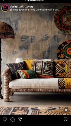 a couch sitting in front of a wall with decorative pillows on it's back