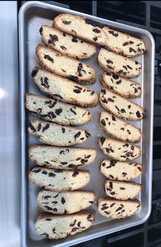 a pan filled with chocolate chip cookies on top of a stove