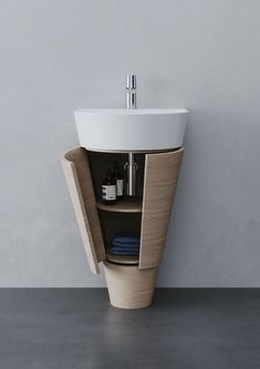 a bathroom sink sitting on top of a wooden cabinet next to a white countertop