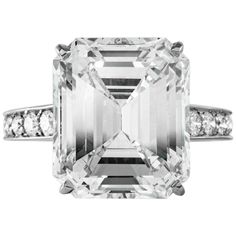 an emerald cut diamond ring with channeled shoulders