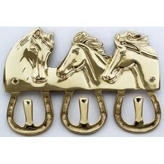 three horse head hooks on a white background, one is gold and the other is black