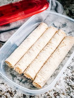 four pieces of tortilla sitting in a plastic container