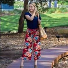 Breezy, Flowy, Cool, And Soft. These Pants Are A Fun Addition To Any Wardrobe Thanks To It's Fun, Striking Colors. Looks Great With Blouses, Tees; Even Sleeveless Sweaters And Fitted Turtlenecks. Floral Pattern On Navy Blue Background. Fabric Has A Great Texture And Weight. Zip Front. Waist Closure Is Button And Hook And Bar. Pockets Are Still Basted Shut. Tags Removed, But Never Made It Out Of My Closet. Flat Lay Measurements Are Approximate. Waist: 16.5" Rise: 10" Inseam: 21" Casual Red Floral Print Bottoms, Casual Red Summer Capris, Sleeveless Sweaters, Fitted Turtleneck, Background Fabric, Wide Leg Cropped Pants, Navy Blue Background, Sleeveless Sweater, Blue Background