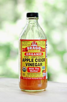 a bottle of apple cider vinegar sitting on a table