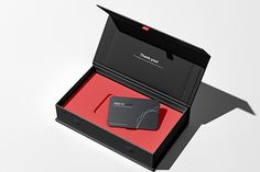 an open black box with a red card inside