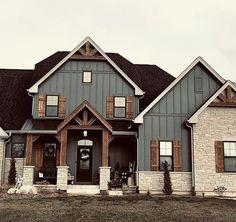 a large gray house with two story windows