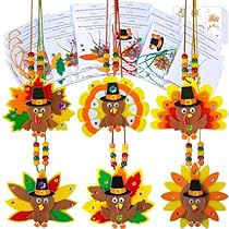 a group of turkeys hanging from strings with hats on them and decorations around the neck