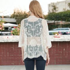 Add a touch of boho flair to your outfit with the Anna-Kaci Women's Short Embroidered Lace Duster Crop Cardigan with Half Sleeves. Blending just the right amount of and modesty, this lace duster keeps your arms and shoulders covered while allowing your outfit to shine through with its sheer lace design. The loose fit, open front, and extra-large armholes ensure a comfortable fit for any body type, creating a dramatic and head-turning flowy look as you walk by. Bohemian Floral Embroidered Cover-up For Spring, Bohemian Cover-up For Layering, Bohemian Cream Cardigan For Day Out, Bohemian Embroidered Cover-up, Bohemian Long Sleeve Embroidered Cover-up, Spring Embroidered Cover-up, Spring Festival Embroidered Cover-up, Bohemian Lace Patchwork Tops For Fall, Bohemian Tops With Lace Patchwork For Fall