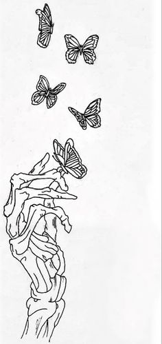 some butterflies are flying in the sky over a person's head and hand with their fingers