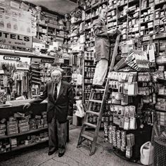 two men are standing on ladders in a store