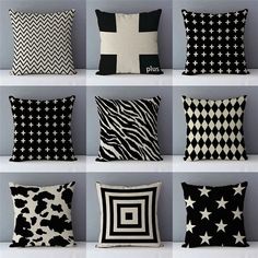 black and white pillows are arranged in rows on the wall, each with different designs