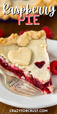 a slice of raspberry pie on a white plate with a fork in it