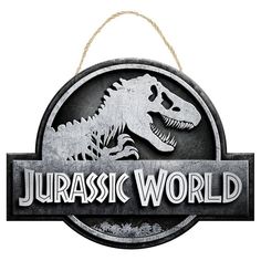 a metal sign that says,'jurassic world'with a dinosaur in the center