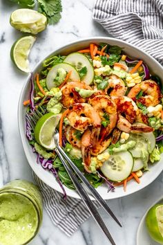 shrimp salad with cucumber, carrots and avocado dressing in a white bowl