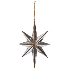 an ornament hanging from a rope on a white background, with a star shaped decoration