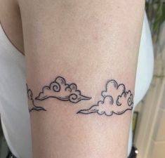 a woman with a cloud tattoo on her arm