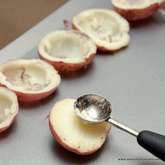 a spoon is being used to scoop out the inside of an apple