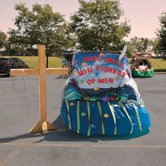 an inflatable boat is sitting on the parking lot next to a sign that says do you fishers of men