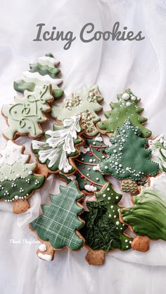 christmas cookies decorated with green and white icing are on a plate, next to the words icing cookies