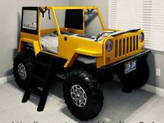 a yellow toy truck bed in the corner of a room with white walls and windows