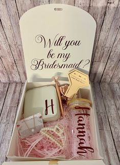 the bridesmaid gift box is filled with personalized items for her special day