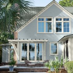 a blue house with white trim and windows