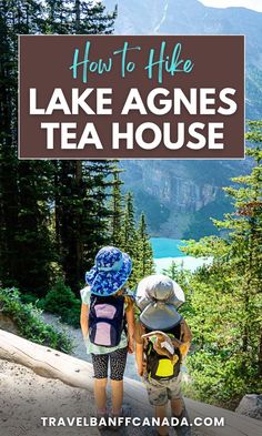 two people with backpacks looking out over lake agnes tea house