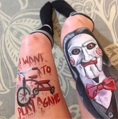 two people with tattoos on their legs that say i want to play game and clown