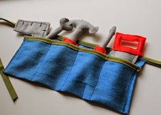 there is a piece of fabric that has been sewn into the shape of a tool belt