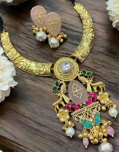 Sabyasachi Inspired Polki Hasli Necklace, featuring a long Kundan pendant in gold-plated fusion. Ideal for blending traditional and contemporary vibes, pair it with a modern saree or fusion outfit. Keep your makeup dewy and your hairstyle sleek to ensure the necklace remains the statement piece. *𝐏𝐑𝐎𝐃𝐔𝐂𝐓 𝐃𝐄𝐓𝐀𝐈𝐋* * Material: Brass * Plating: Gold Plated. * Stone: Semi Precious Carved Stones, Kundan, Polki *𝐃𝐈𝐒𝐂𝐋𝐀𝐈𝐌𝐄𝐑* Product color may slightly vary due to photographic ligh Gold Long Necklace With Meenakari, Festive Fusion Style Gold Plated Necklaces, Gold Kundan Necklace With Latkans, Gold Chandbali Necklace With Latkans, Gold Plated Latkans Necklaces For Festivals, Gold Plated Necklaces With Latkans For Festivals, Festival Gold-plated Necklaces With Latkans, Traditional Brass Necklace For Party, Gold Plated Meenakari Necklaces