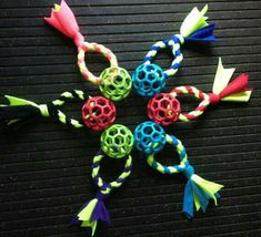 several colorful bracelets with tassels on top of a black surface in the shape of an eight - pointed star