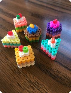 four legos are arranged on a table and one is made out of different colored blocks