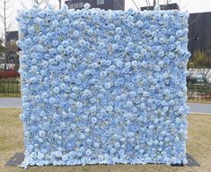 a large blue flowered wall in the middle of a park