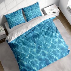 a bed with blue water and white sheets