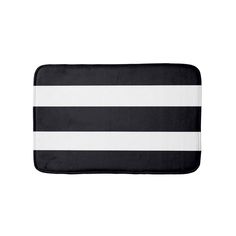 a black and white striped bath mat on a white background, with horizontal stripes in the middle