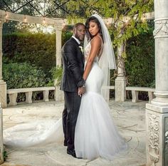 a bride and groom posing for a photo in front of a gazebo at their wedding