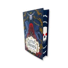 the little thieves book is open to reveal an image of a woman with horns on her head