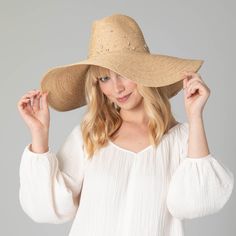 Our Glitz Wide Brim Fedora Sun Hat is a luxurious accessory for your summertime wardrobe. The delicate braid raffia is carefully crafted with attention to detail, and embedded with rhinestones to add a touch of sparkle. The 6" brim offers UPF 50+ sun protection and is adjustable for a perfect fit. Boasting a classic natural color and crafted from 100% premium raffia, this floppy fedora is a must-have for any fashionable collection. Features: Color: NaturalMaterials: 100% RaffiaBrim Size: 6" Brim Luxury Short Brim Straw Hat For The Beach, Luxury Short Brim Straw Hat For Beach, Luxury Straw Hat With Short Brim For Beach, Luxury Curved Brim Sun Hat For Beach, Luxury Straw Hat For Beach, Luxury Panama Hat For Summer Beach, Luxury Beach Hats For Summer, Luxury Natural Straw Hat For Beach, Luxury Beach Sun Hat For Spring