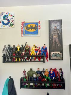 there are many toy action figures on the shelves in this room, including batman and robin wayne