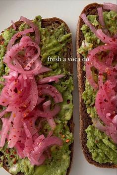 two halves of bread with guacamole and onions