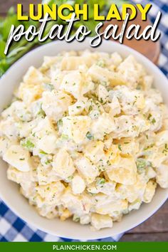 a white bowl filled with potato salad on top of a blue and white checkered table cloth