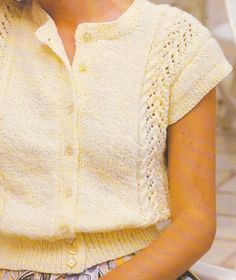 a woman wearing a yellow knitted sweater