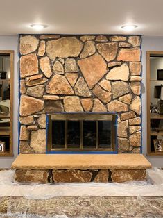 a stone fireplace in a living room under construction