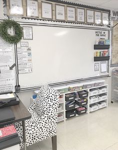 a classroom with whiteboard, desks and chairs