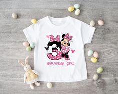 a minnie mouse birthday shirt with the number three on it and a stuffed animal next to it