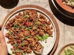 a plate full of food sitting on top of a table next to other plates and bowls