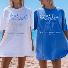 two women standing next to each other on the beach wearing t - shirts that say coastal carolina